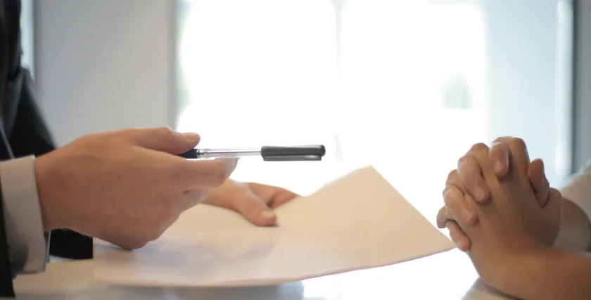 Signing documents at a desk
