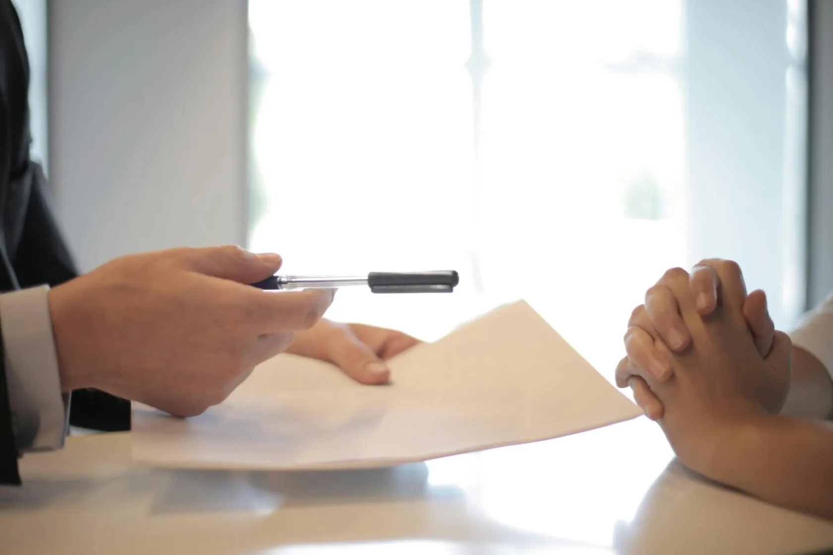 Signing documents at a desk